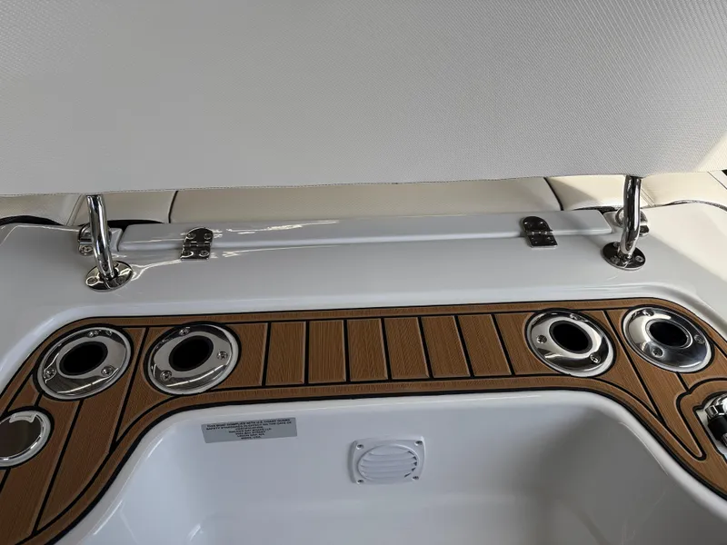 Slide: The Image of 2025 Walker Bay Generation 14 LTE boat interior with cup holders and wood accents. - 14