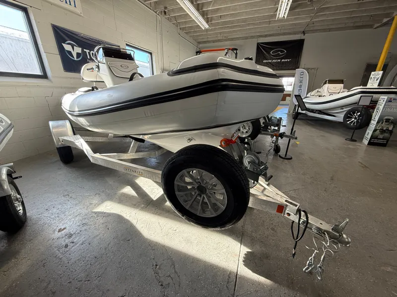 Slide: The Image of 2025 Walker Bay Generation 14 LTE boat on trailer in showroom. - 15