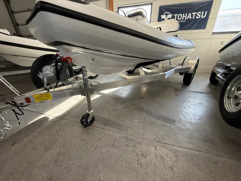 Slide: The Image of 2025 Walker Bay Generation 14 LTE boat on trailer in showroom. - 16