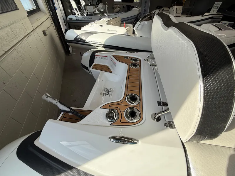 Slide: The Image of 2025 Walker Bay Generation 14 LTE boat interior with seating and control panel. - 5