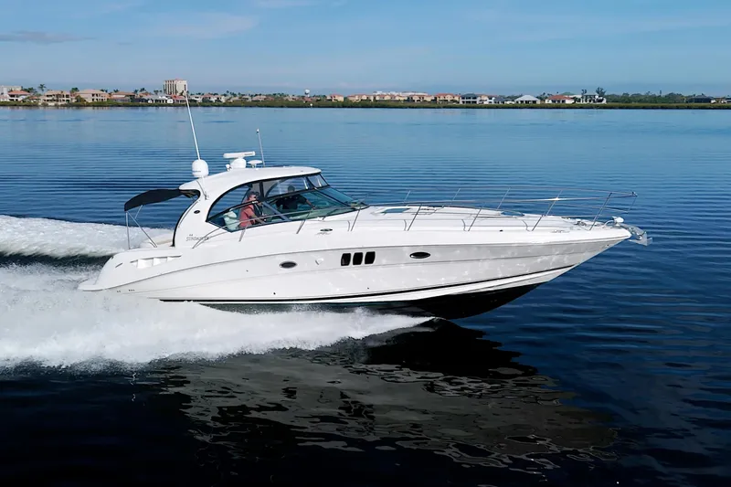 Slide: The Image of 2009 Sea Ray 44 Sundancer cruising on calm water. - 1