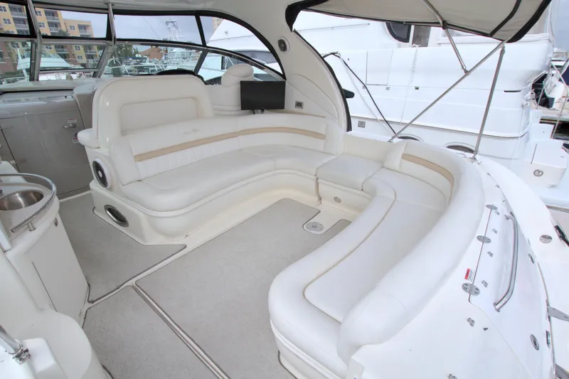 Slide: The Image of 2009 Sea Ray 44 Sundancer yacht interior with spacious white seating area. - 14