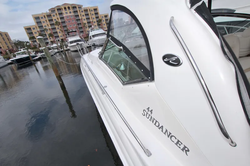 Slide: The Image of 2009 Sea Ray 44 Sundancer yacht docked at marina with waterfront buildings. - 16