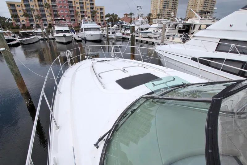 Slide: The Image of 2009 Sea Ray 44 Sundancer yacht docked in a marina with other boats. - 17