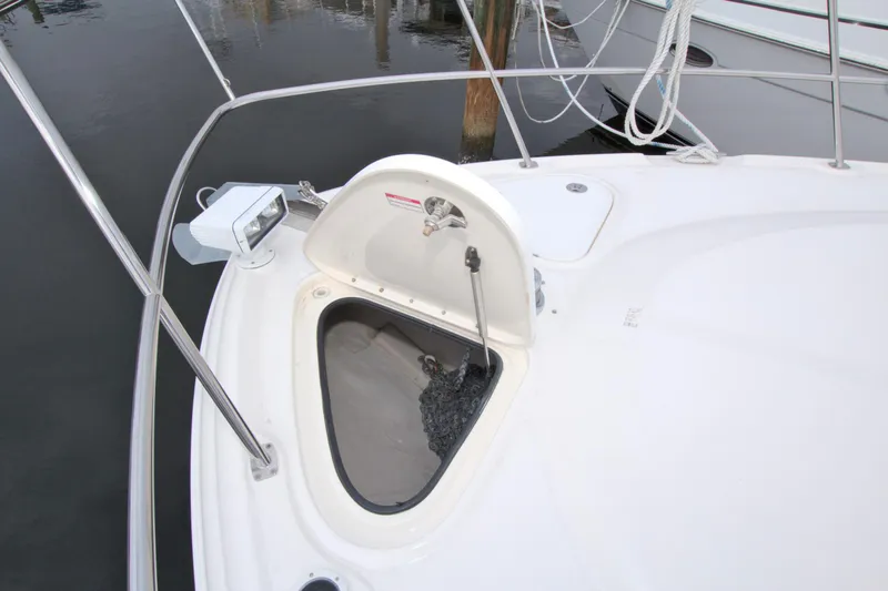 Slide: The Image of 2009 Sea Ray 44 Sundancer anchor locker on deck, featuring stainless steel railing. - 19