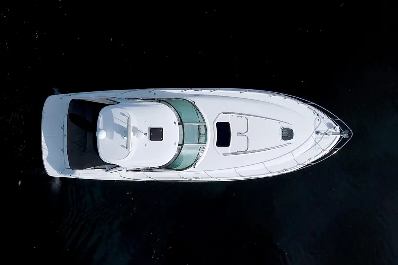 Slide: The Image of 2009 Sea Ray 44 Sundancer yacht, aerial view, sleek white design on dark water. - 2