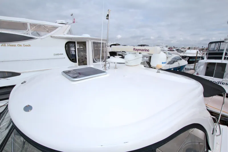 Slide: The Image of 2009 Sea Ray 44 Sundancer yacht docked among other boats. - 24
