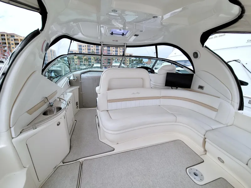 Slide: The Image of 2009 Sea Ray 44 Sundancer yacht interior with luxurious white seating and modern amenities. - 26