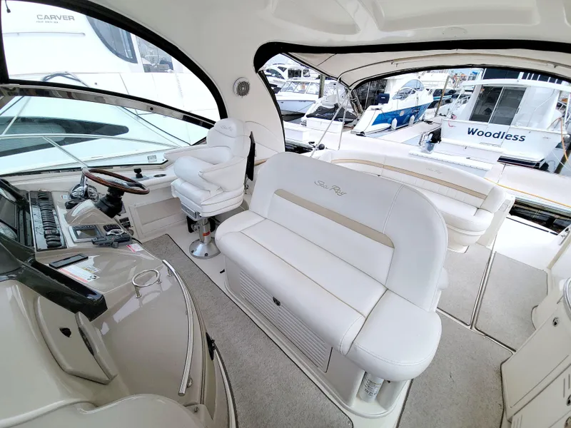 Slide: The Image of Interior of 2009 Sea Ray 44 Sundancer yacht with white seating and control panel. - 27