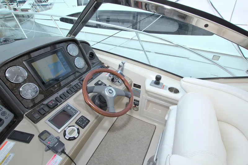Slide: The Image of Helm of 2009 Sea Ray 44 Sundancer with modern navigation controls and plush seating. - 30