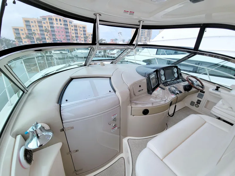 Slide: The Image of 2009 Sea Ray 44 Sundancer helm with modern controls and panoramic windows. - 32