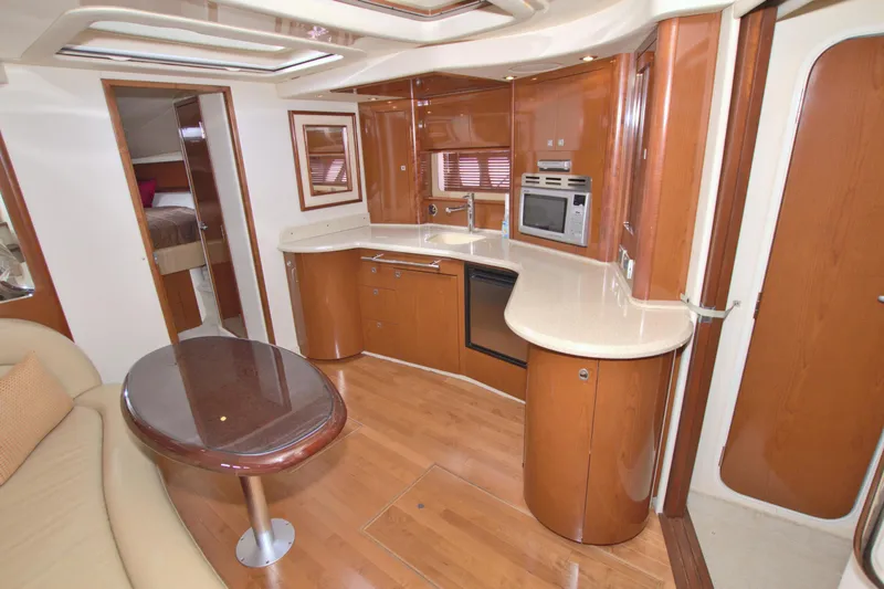 Slide: The Image of 2009 Sea Ray 44 Sundancer yacht interior with modern kitchen and seating area. - 35