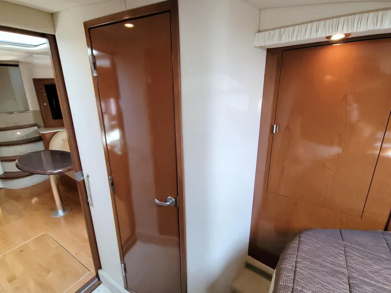 Slide: The Image of Interior of 2009 Sea Ray 44 Sundancer yacht, featuring wood paneling and cozy cabin space. - 39