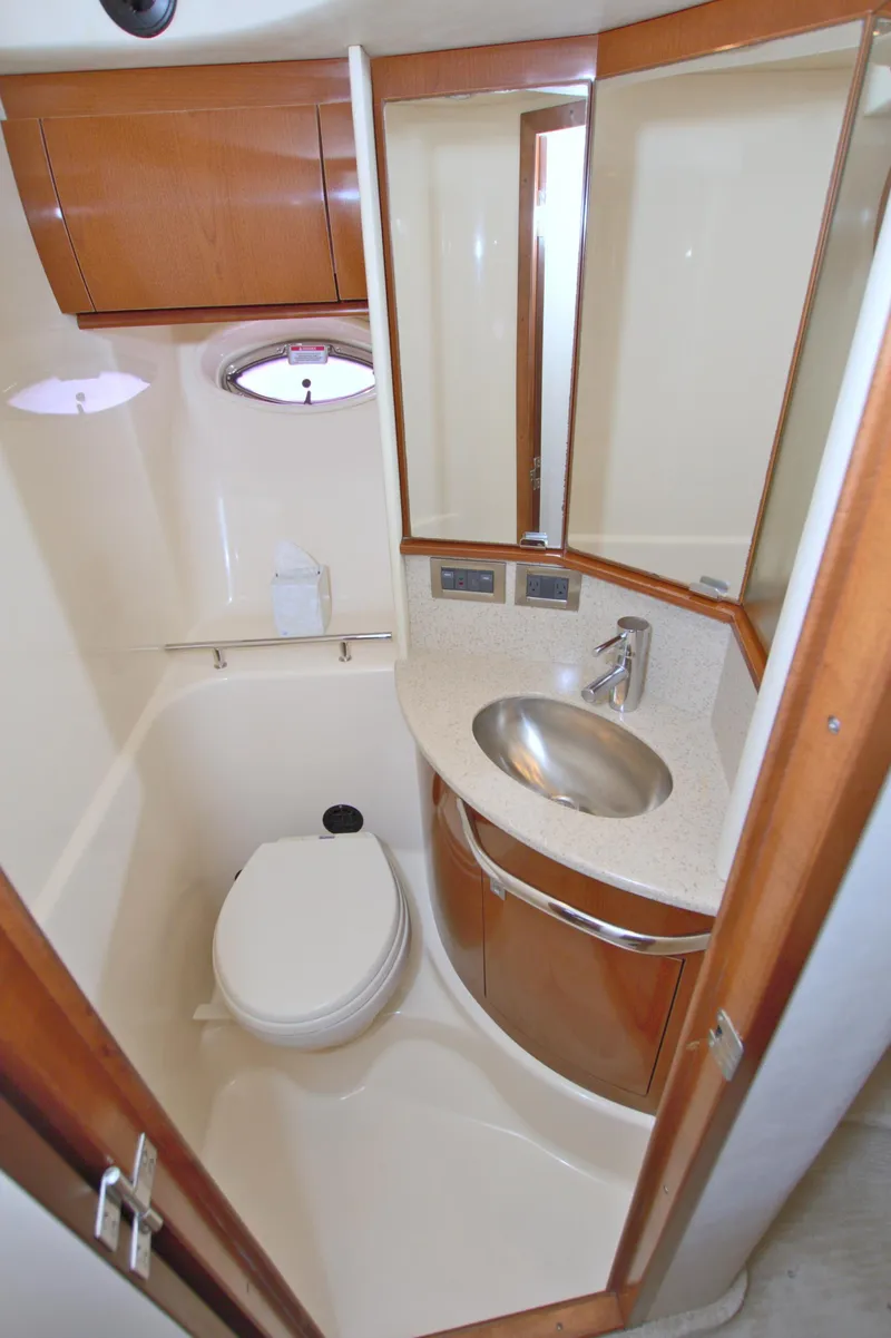 Slide: The Image of 2009 Sea Ray 44 Sundancer yacht bathroom with modern fixtures and wooden cabinetry. - 41