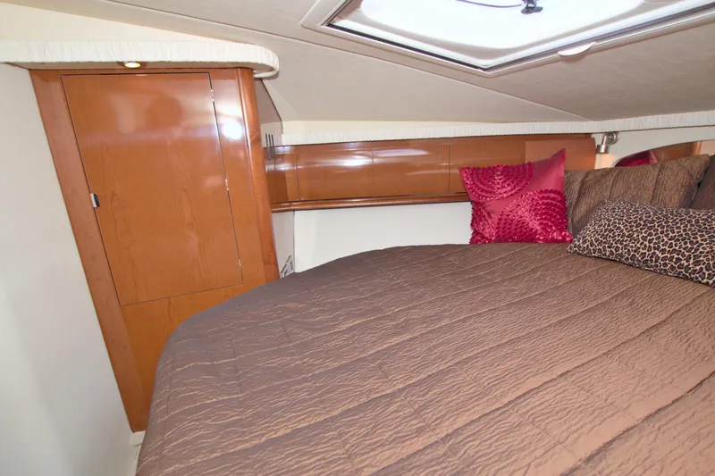 Slide: The Image of 2009 Sea Ray 44 Sundancer cabin with cozy bed and stylish pillows. - 42