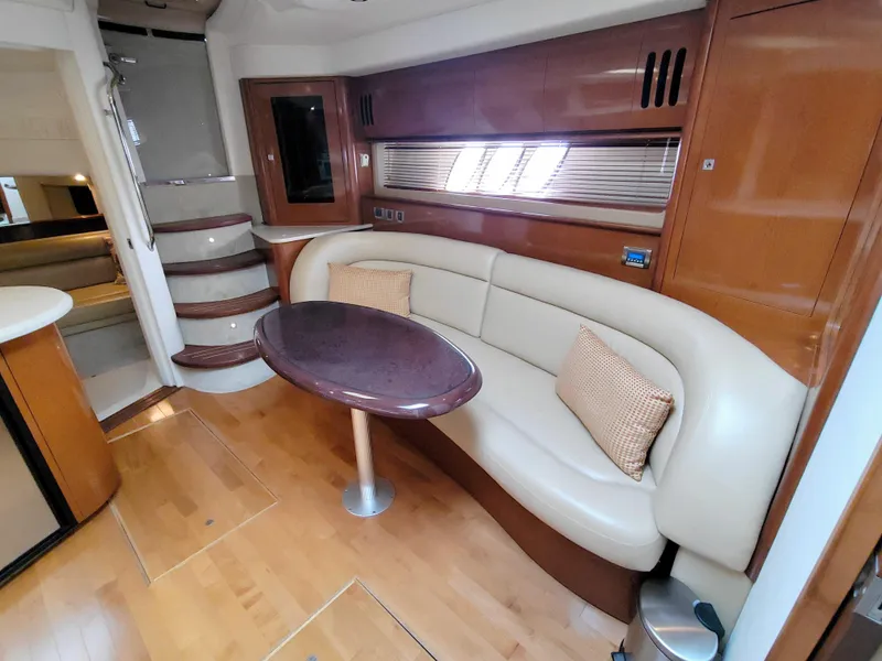 Slide: The Image of Interior of 2009 Sea Ray 44 Sundancer yacht with elegant seating and wooden finishes. - 49