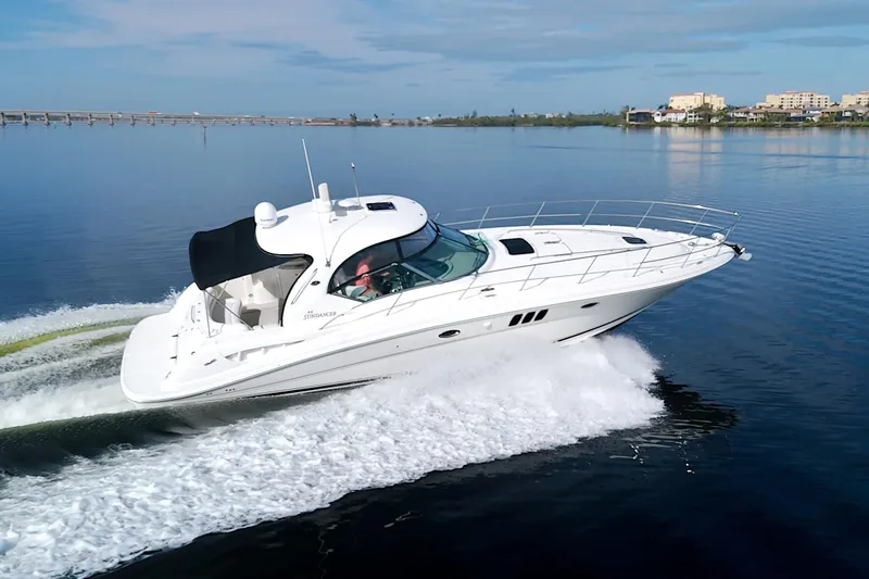 Slide: The Image of 2009 Sea Ray 44 Sundancer cruising on calm waters under a clear sky. - 5