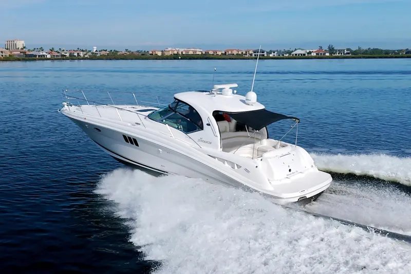 Slide: The Image of 2009 Sea Ray 44 Sundancer cruising on open water, showcasing sleek design and performance. - 8
