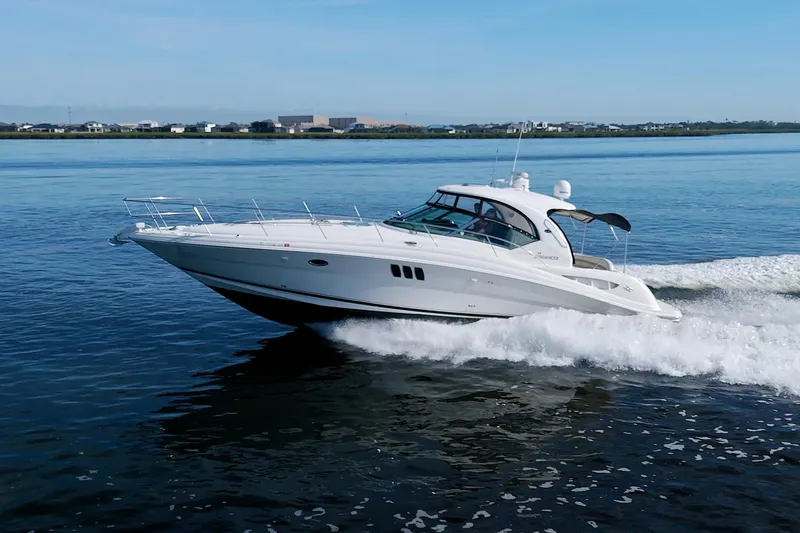 Slide: The Image of 2009 Sea Ray 44 Sundancer yacht cruising on calm waters. - 9