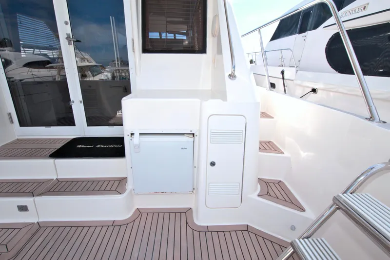 Slide: The Image of 1999 West Bay 58 Sonship yacht deck with steps and storage compartments. - 17