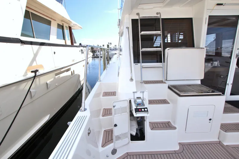Slide: The Image of 1999 West Bay 58 Sonship yacht deck with steps and railing. - 20