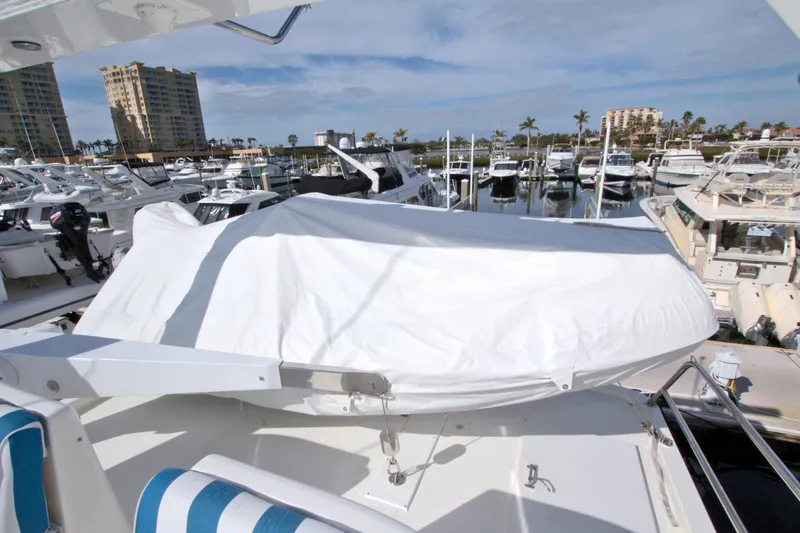 Slide: The Image of 1999 West Bay 58 Sonship yacht at marina, covered deck, surrounded by boats. - 21