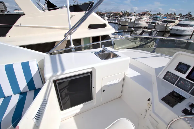 Slide: The Image of Cockpit view of 1999 West Bay 58 Sonship yacht with marina background. - 26