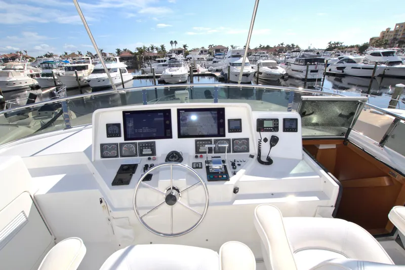 Slide: The Image of Cockpit of 1999 West Bay 58 Sonship yacht with marina view. - 28