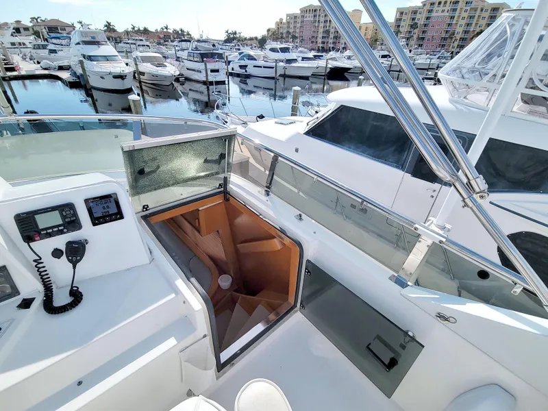 Slide: The Image of 1999 West Bay 58 Sonship yacht interior with marina view, featuring control panel and stairs. - 32