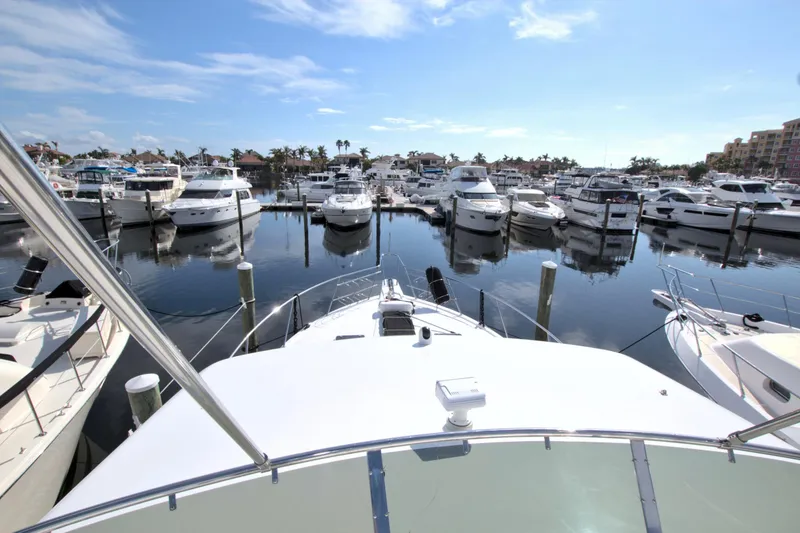 Slide: The Image of 1999 West Bay 58 Sonship yacht docked in a marina with multiple boats. - 33