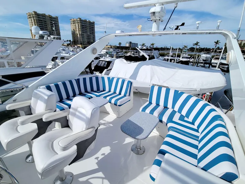 Slide: The Image of Luxurious 1999 West Bay 58 Sonship yacht with striped seating on deck. - 34
