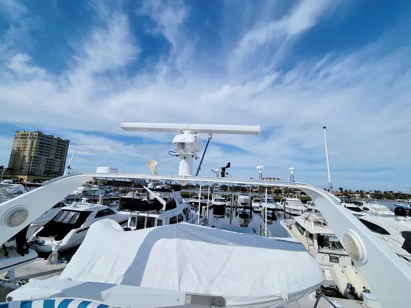 Slide: The Image of 1999 West Bay 58 Sonship yacht docked in a marina under a blue sky. - 35