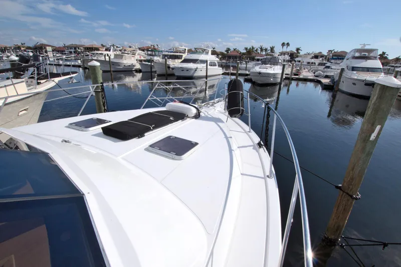 Slide: The Image of 1999 West Bay 58 Sonship yacht docked in a marina under clear skies. - 40