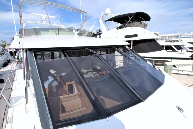 Slide: The Image of 1999 West Bay 58 Sonship yacht docked, showcasing sleek design and spacious interior. - 41