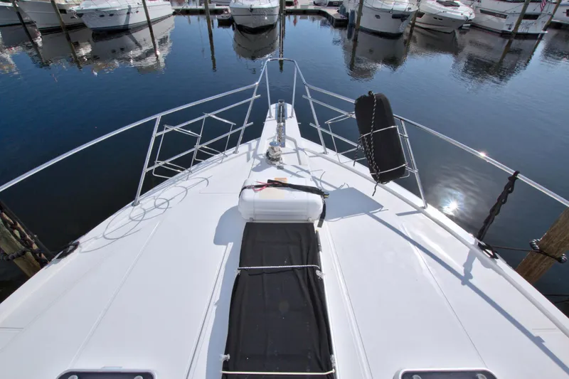 Slide: The Image of 1999 West Bay 58 Sonship yacht bow view at marina. - 42