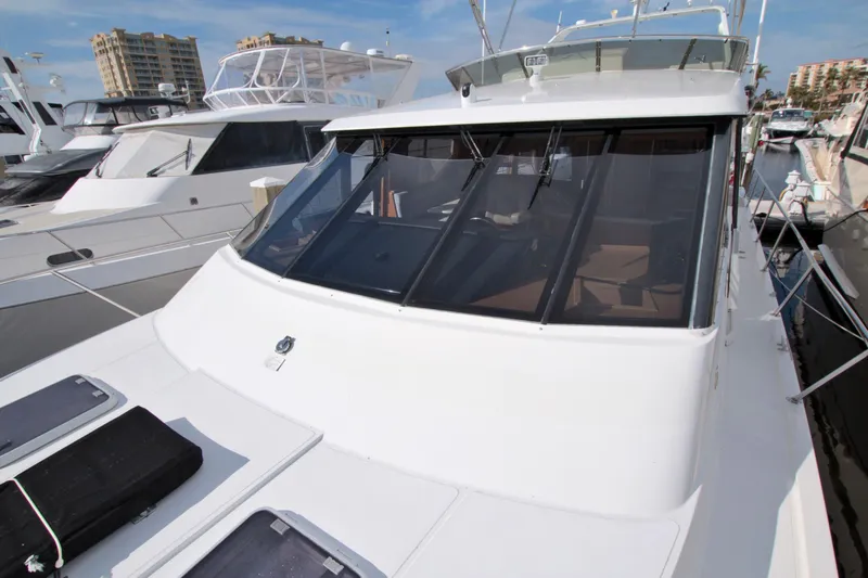 Slide: The Image of 1999 West Bay 58 Sonship yacht docked at marina, featuring sleek design and spacious deck. - 45