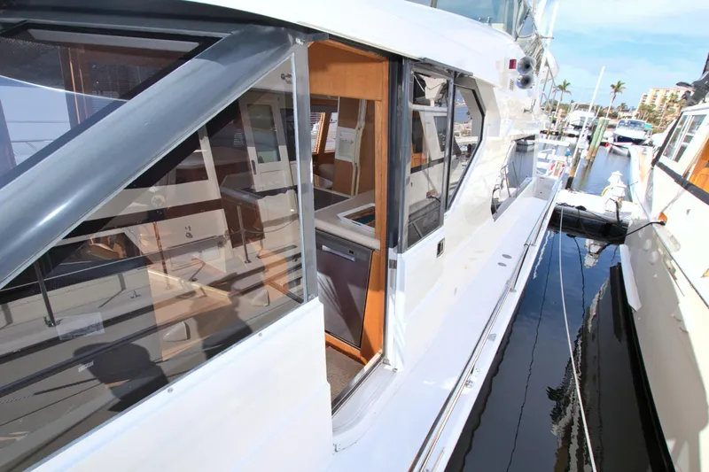 Slide: The Image of 1999 West Bay 58 Sonship yacht docked, showcasing sleek design and spacious interior. - 46