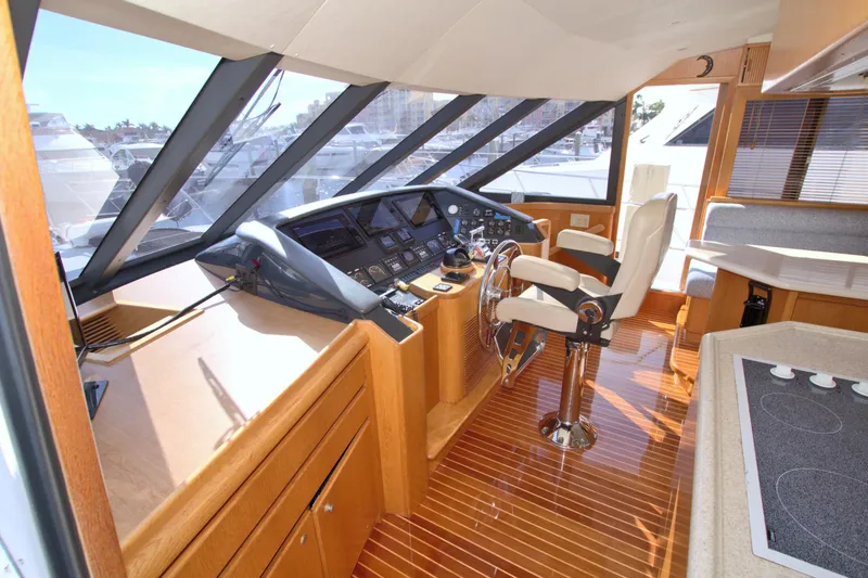 Slide: The Image of Interior helm of 1999 West Bay 58 Sonship yacht with modern controls and seating. - 48