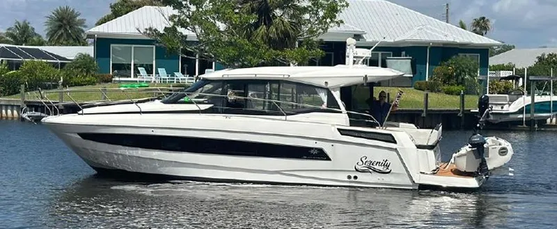 The Image of 2020 Jeanneau NC 37 boat named "Serenity" cruising on a calm waterway. - 0