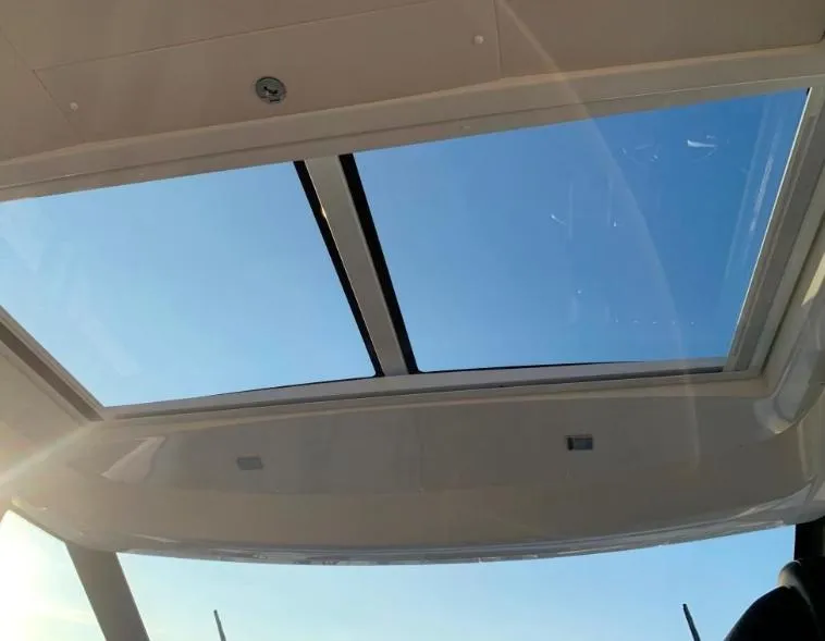 Slide: The Image of Sunroof view from 2020 Jeanneau NC 37 boat, showcasing clear blue sky. - 10