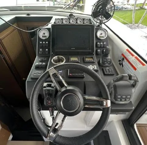 Slide: The Image of Cockpit of 2020 Jeanneau NC 37 boat with steering wheel and control panel. - 12