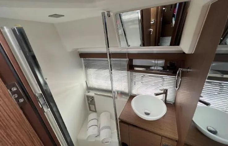 Slide: The Image of Modern bathroom in 2020 Jeanneau NC 37 yacht with sleek fixtures and wooden accents. - 16