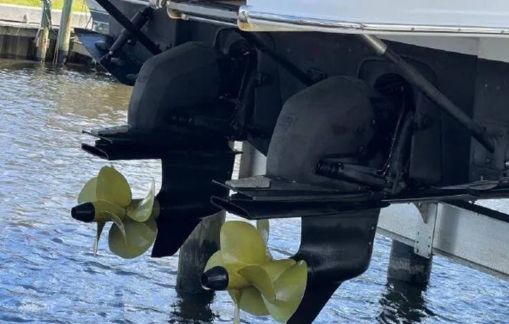 Slide: The Image of Twin propellers of a 2020 Jeanneau NC 37 boat in water. - 21