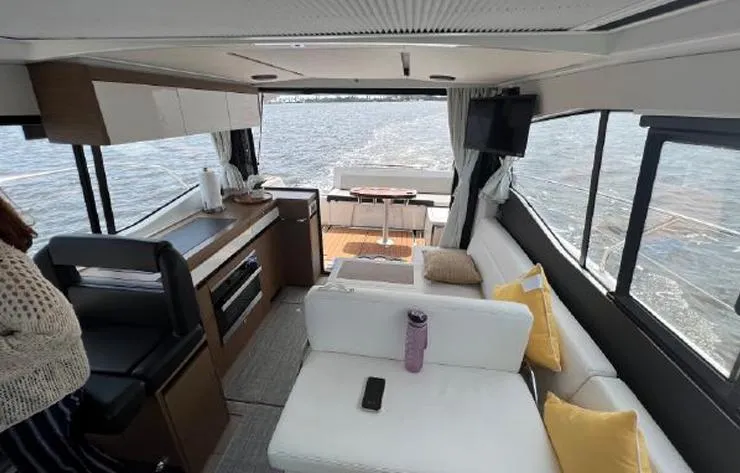 Slide: The Image of Interior of 2020 Jeanneau NC 37 yacht with modern seating and kitchen area. - 6