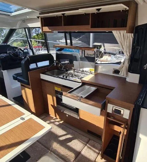 Slide: The Image of 2020 Jeanneau NC 37 yacht interior with modern kitchen and dining area. - 8
