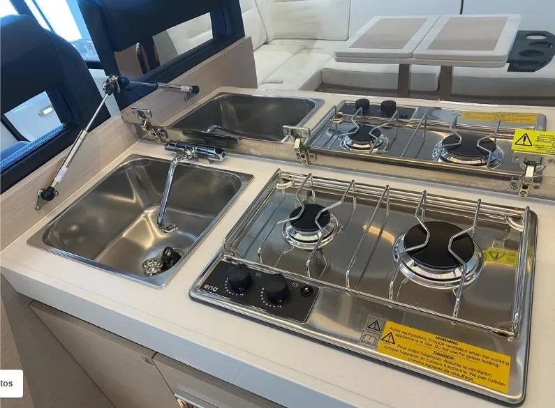 Slide: The Image of Compact kitchen area in a 2020 Jeanneau NC 37 boat with stove and sink. - 9