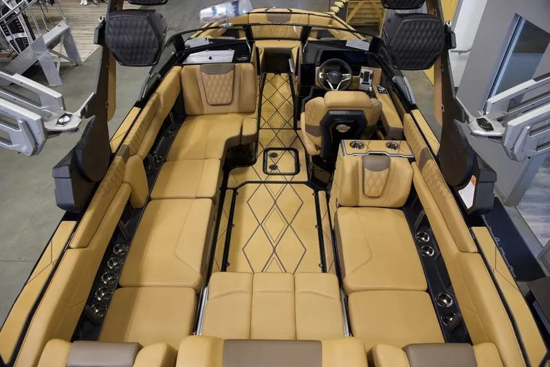Slide: The Image of Luxurious interior of 2025 Malibu M242 boat with tan leather seating and modern design. - 11