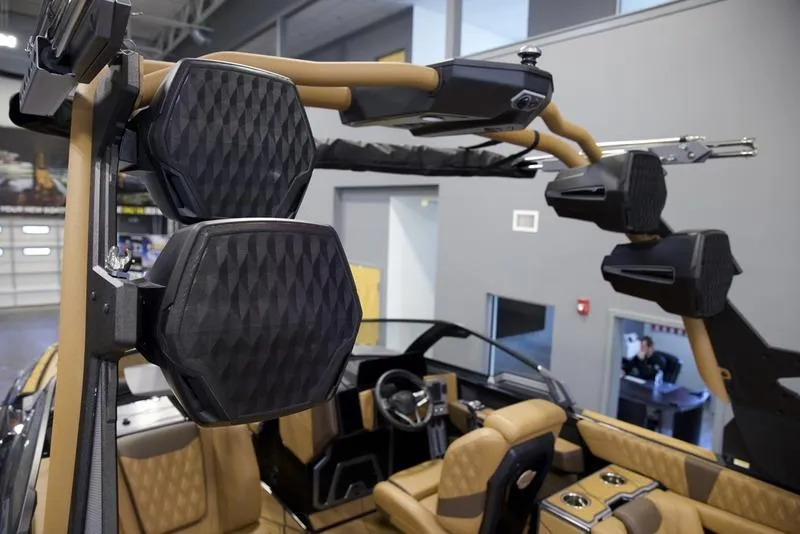 Slide: The Image of 2025 Malibu M242 boat interior with advanced audio system and luxurious seating. - 12