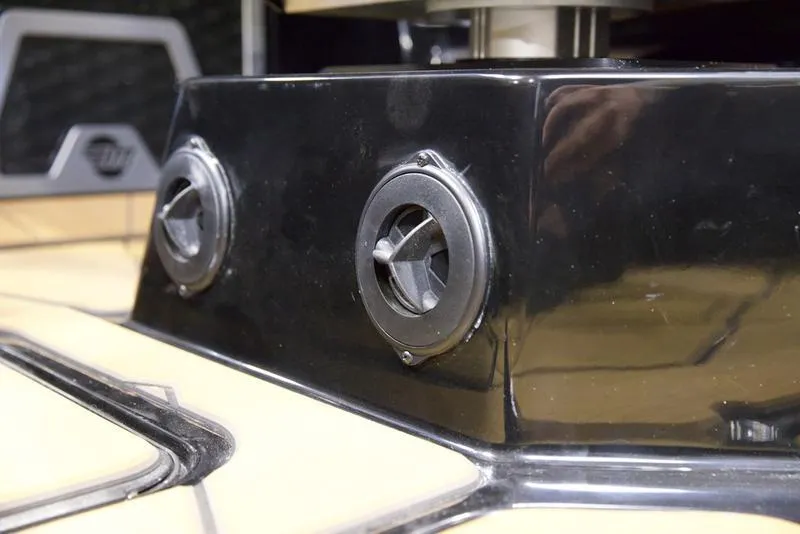 Slide: The Image of 2025 Malibu M242 boat interior detail with sleek black and chrome design elements. - 14