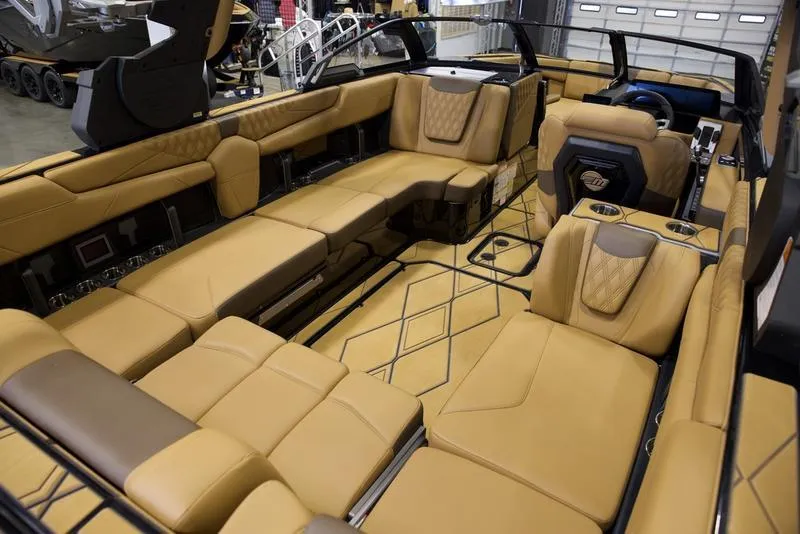 Slide: The Image of Luxurious interior of 2025 Malibu M242 boat with tan leather seating. - 19